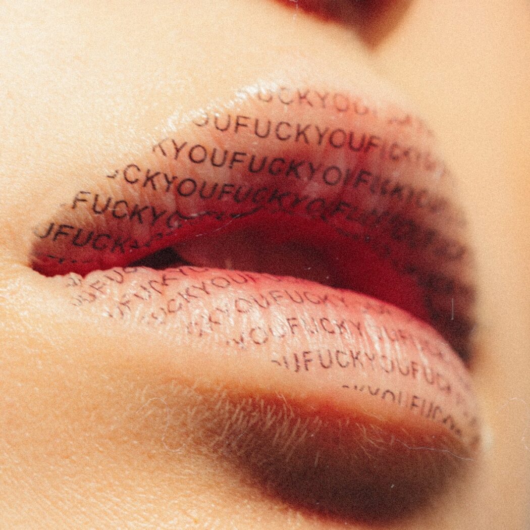 lips with the words fuck you on them